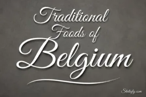 Traditional foods of Belgium are showcased on a stylish sign with elegant script and a dark background.